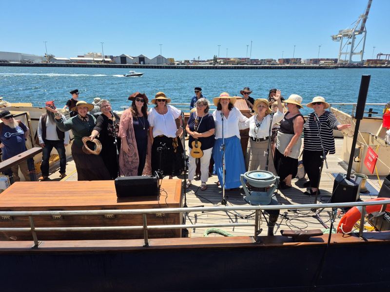 She Shants singing on the deck of a tall ship in the harbour